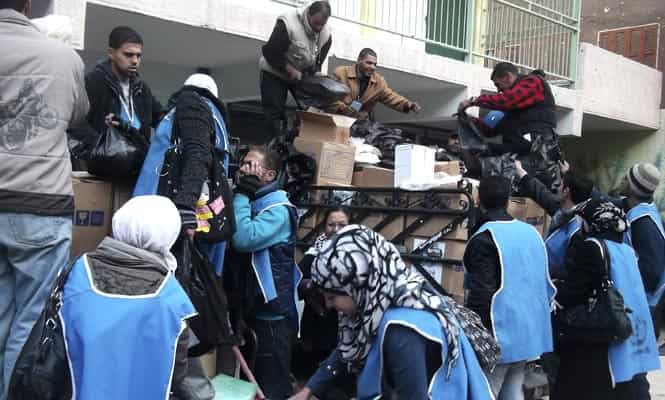 U.N. Relief and Works Agency (UNRWA) workers prepare aid parcels at the Palestinian refugee camp of Yarmouk, south of Damascus (Reuters photo) U.N. Relief and Works Agency (UNRWA) workers prepare aid parcels at the Palestinian refugee camp of Yarmouk, south of Damascus (Reuters photo)