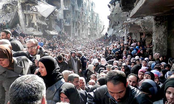 Residents of the besieged Palestinian camp of Yarmouk line up to receive food supplies, in Damascus, Syria (AP photo) Residents of the besieged Palestinian camp of Yarmouk line up to receive food supplies, in Damascus, Syria (AP photo)