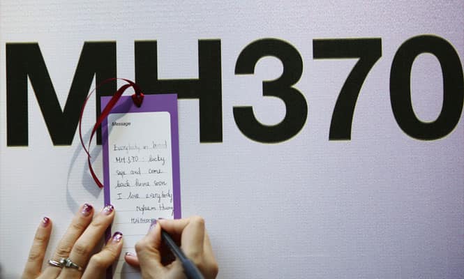 A tourist from Vietnam writes a message expressing hope for family members and those onboard the missing Malaysia Airlines flight MH370, in Kuala Lumpur. (Reuters Photo) A tourist from Vietnam writes a message expressing hope for family members and those onboard the missing Malaysia Airlines flight MH370, in Kuala Lumpur. (Reuters Photo)