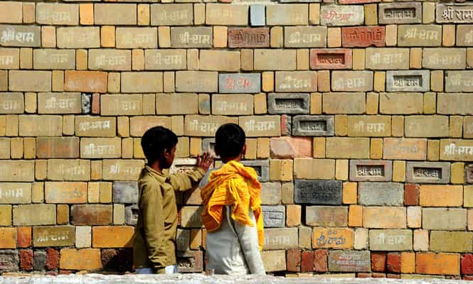 Hindu youth of the Veda Vidyalaya stand at a wall of bricks bearing the name of 'Shri Ram' at the Karsevak Puram workshop in Ayodhya. (AFP photo) Hindu youth of the Veda Vidyalaya stand at a wall of bricks bearing the name of 'Shri Ram' at the Karsevak Puram workshop in Ayodhya. (AFP photo)