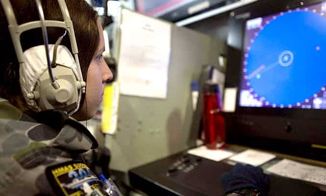 Able Seaman Emma Searle works in an operations room of the Australian Navy ship, the HMAS Success, in a search area for missing Malaysian Airlines Flight MH370.(Reuters)