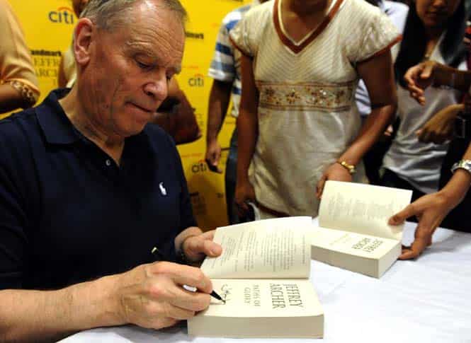 Author Jeffrey Archer signs a book during a book signing session in Mumbai. (AFP file photo)</strong) Author Jeffrey Archer signs a book during a book signing session in Mumbai. (AFP file photo)</strong)