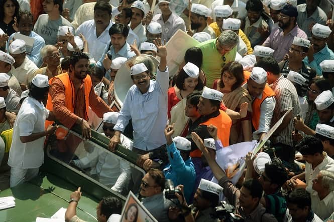 Aam Admi Party chief Arvind Kejriwal waves to his supporters during a road show in Mumbai ahead of Lok Sabha polls. (AFP Photo)</em) Aam Admi Party chief Arvind Kejriwal waves to his supporters during a road show in Mumbai ahead of Lok Sabha polls. (AFP Photo)</em)