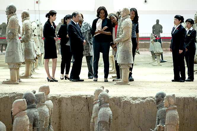 US first lady Michelle Obama checks a terracotta warrior as she visits Qinshihuang Terracotta Warriors and Horses Museum with her daughters, Malia and Sasha and her mother, Marian Shields Robinson. (AP Photo)
</div) US first lady Michelle Obama checks a terracotta warrior as she visits Qinshihuang Terracotta Warriors and Horses Museum with her daughters, Malia and Sasha and her mother, Marian Shields Robinson. (AP Photo)
</div)