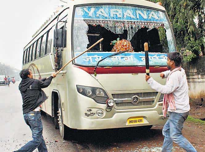 AJSU Party activists damage a bus, in Jamshedpur on Sunday. (PTI Photo) AJSU Party activists damage a bus, in Jamshedpur on Sunday. (PTI Photo)