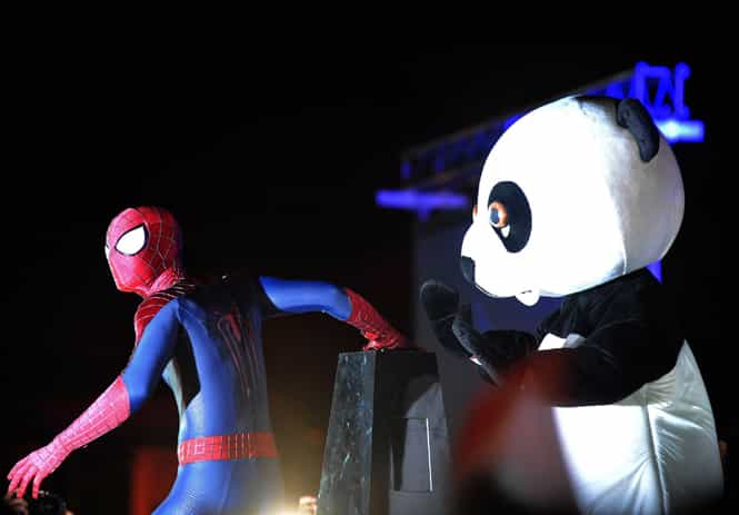 A performer dressed as Spiderman and the WWF panda mascot prepare to turn off the lights from a floating platform for Earth Hour in Singapore. (AFP photo)</em) A performer dressed as Spiderman and the WWF panda mascot prepare to turn off the lights from a floating platform for Earth Hour in Singapore. (AFP photo)</em)