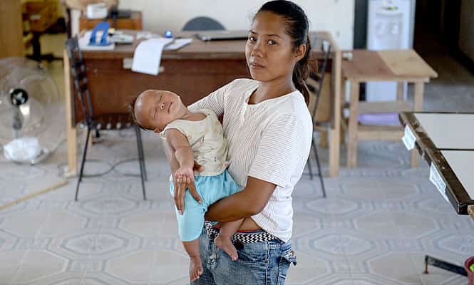 In this photo taken on February 15, 2014, Typhoon Haiyan survivor Emily Sagalis stands next to her baby inside their tent that is serving as temporary shelter. (AFP Photo) In this photo taken on February 15, 2014, Typhoon Haiyan survivor Emily Sagalis stands next to her baby inside their tent that is serving as temporary shelter. (AFP Photo)