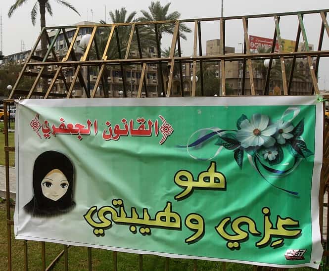 A banner reading in Arabic "the Jaafari law (Jaafari Personal Status Law) is my glory and my pride" in Baghdad. (AFP Photo)</em) A banner reading in Arabic "the Jaafari law (Jaafari Personal Status Law) is my glory and my pride" in Baghdad. (AFP Photo)</em)