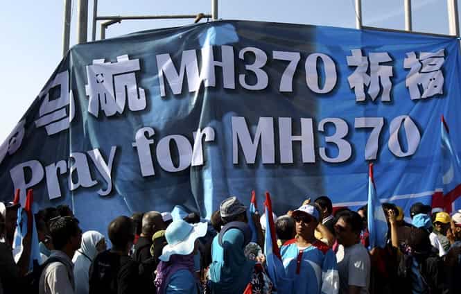 Supporters of Malaysian opposition People's Justice Party hold up a banner reading "Pray for MH370" outside a nomination center in Bangi, outside Kuala Lumpur, Malaysia. (AP Photo) Supporters of Malaysian opposition People's Justice Party hold up a banner reading "Pray for MH370" outside a nomination center in Bangi, outside Kuala Lumpur, Malaysia. (AP Photo)