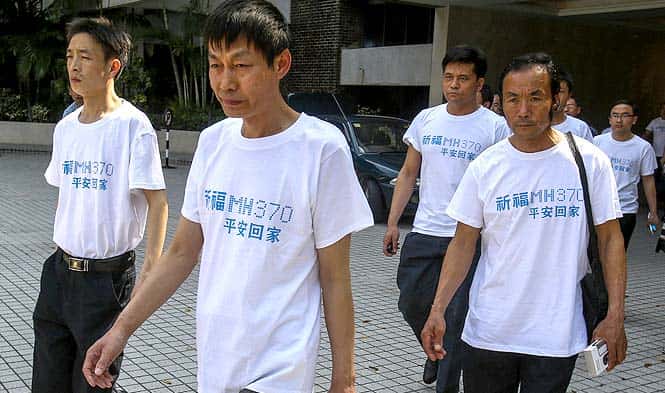 Chinese relatives of passengers onboard the missing MH370 jet make their way to a meeting at the Holiday Villa in Subang Jaya. (Reuters photo)</em) Chinese relatives of passengers onboard the missing MH370 jet make their way to a meeting at the Holiday Villa in Subang Jaya. (Reuters photo)</em)
