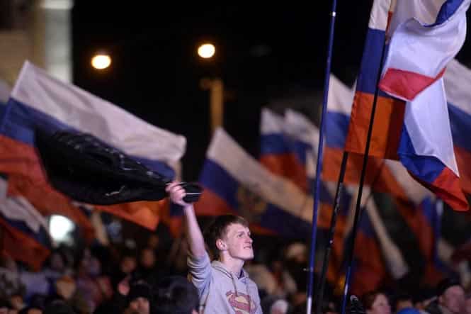 A pro-Russian protester celebrates in Simferopol's Lenin Square on March 16, 2014 after exit polls showed that about 95% of voters in Ukraine's Crimea region supported union with Russia (AFP photo) A pro-Russian protester celebrates in Simferopol's Lenin Square on March 16, 2014 after exit polls showed that about 95% of voters in Ukraine's Crimea region supported union with Russia (AFP photo)