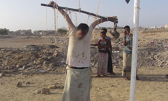 The body of a man is seen tied to a soccer goal post after al Qaeda militants shot him to death accusing him of spying for the US outside al-Shihr city in Yemen. (Reuters photo)
</div) The body of a man is seen tied to a soccer goal post after al Qaeda militants shot him to death accusing him of spying for the US outside al-Shihr city in Yemen. (Reuters photo)
</div)
