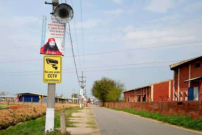 A hoarding shows an image of spiritual leader Ashutosh Maharaj outside the Divya Jyoti Jagrati Sansthan in Nurmahal on the outskirts of Jalandhar. (AFP photo) A hoarding shows an image of spiritual leader Ashutosh Maharaj outside the Divya Jyoti Jagrati Sansthan in Nurmahal on the outskirts of Jalandhar. (AFP photo)