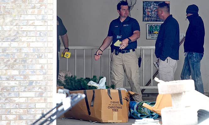 Pleasant Grove Police investigate the scene where seven infant bodies were discovered and packaged in separate containers at a home in Pleasant Grove, Utah. (AP photo)