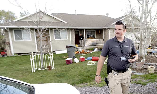 Pleasant Grove Police investigate the scene where seven infant bodies were discovered and packaged in separate containers at a home in Pleasant Grove, Utah. (AP photo)