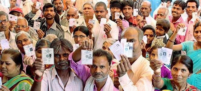 Voters showing their ID cards as they wait to cast their votes at a polling station in Nagpur. Photo by PTI Voters showing their ID cards as they wait to cast their votes at a polling station in Nagpur. Photo by PTI