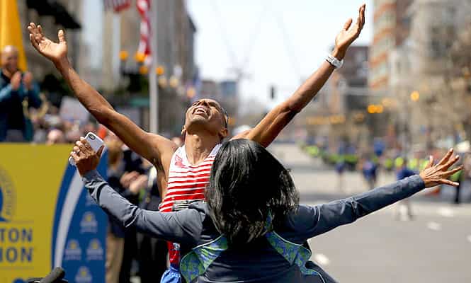 Meb Keflezighi of the U.S. celebrates with his wife Yordanos Asgedom after winning the men's division at the 118th running of the Boston Marathon in Boston, Massachusetts April 21, 2014. (Reuters)</em) Meb Keflezighi of the U.S. celebrates with his wife Yordanos Asgedom after winning the men's division at the 118th running of the Boston Marathon in Boston, Massachusetts April 21, 2014. (Reuters)</em)