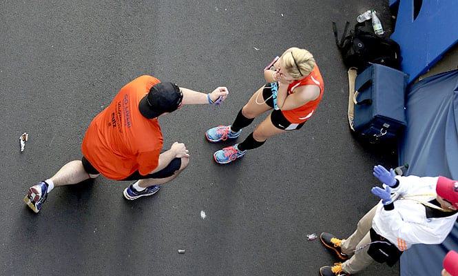 Joseph Brayton, left, proposes marriage to Kara Flaherty, both of Boston, after they crossed the finish line of the 118th Boston Marathon in Boston. (AP Photo)</em) Joseph Brayton, left, proposes marriage to Kara Flaherty, both of Boston, after they crossed the finish line of the 118th Boston Marathon in Boston. (AP Photo)</em)