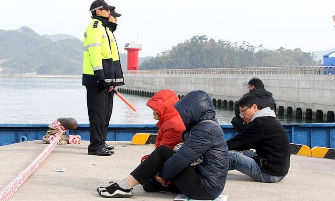 Relatives of passengers aboard the sunken Sewol ferry wait for their missing loved ones at a port in Jindo, South Korea. (AP Photo)</em) Relatives of passengers aboard the sunken Sewol ferry wait for their missing loved ones at a port in Jindo, South Korea. (AP Photo)</em)