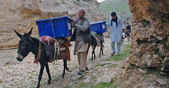 Afghan election workers use donkeys to transport ballot boxes and election materials to polling stations as walking through Mazar-i-Sharif to Kishindih district in Balkh province, Afghanistan. (AP Photo)
</div) Afghan election workers use donkeys to transport ballot boxes and election materials to polling stations as walking through Mazar-i-Sharif to Kishindih district in Balkh province, Afghanistan. (AP Photo)
</div)