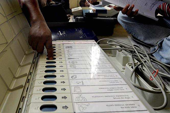 An election official checks an Electronic Voting Machine (EVM) prior to distribution to polling officials at Agartala, the capital of Tripura. (AFP photo)</em>
</div) An election official checks an Electronic Voting Machine (EVM) prior to distribution to polling officials at Agartala, the capital of Tripura. (AFP photo)</em>
</div)