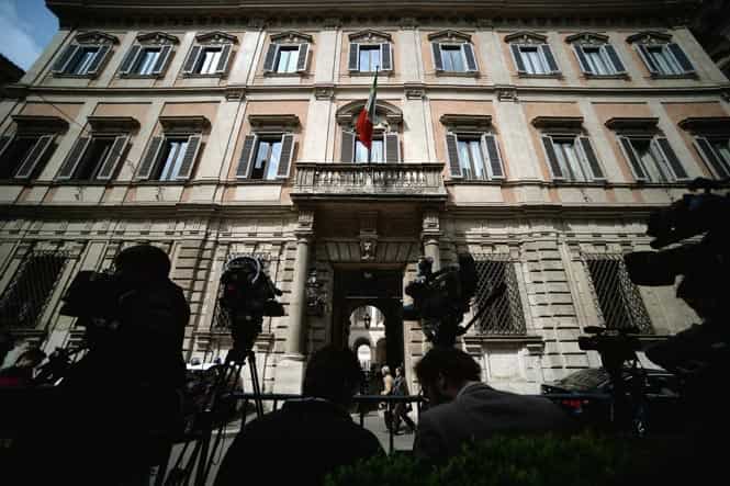 Television crews wait outside former Italian prime minister Silvio Belusconi's residence in downtown Rome. (AFP photo) 
</div)