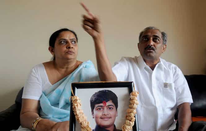 Dipti Lodaya (L) holds her son Dhawal's photo as her husband Mayur Lodaya speaks of the tragedy that has befallen their family at their home in Mumbai. (AFP photo)
</div) Dipti Lodaya (L) holds her son Dhawal's photo as her husband Mayur Lodaya speaks of the tragedy that has befallen their family at their home in Mumbai. (AFP photo)
</div)