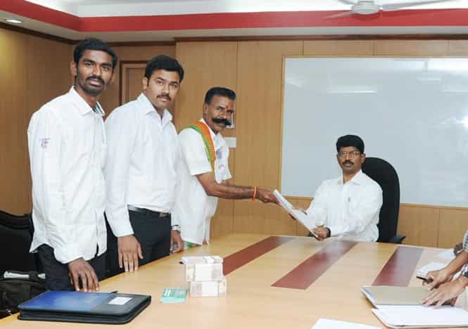 Shop owner K Padmarajan poses alongside a returning officer as he hands over papers relating to his 158th electoral contest in Dharmapuri in Tamil Nadu. (AFP photo/K Padmarajan)
</div) Shop owner K Padmarajan poses alongside a returning officer as he hands over papers relating to his 158th electoral contest in Dharmapuri in Tamil Nadu. (AFP photo/K Padmarajan)
</div)