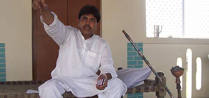 A senior overseas migrant worker Mohammed Amir, on an election vacation, sitting in his village house built by the money he earns in Riyadh. (Pankaj Jaiswal/HT photo) 
</div)