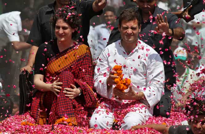 Priyanka Gandhi Vadra is showered with rose petals by supporters upon brother Rahul's arrival to file his nomination for the general election at Amethi. (Reuters Photo)</em) Priyanka Gandhi Vadra is showered with rose petals by supporters upon brother Rahul's arrival to file his nomination for the general election at Amethi. (Reuters Photo)</em)