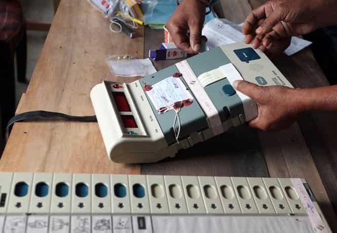 Election Commission officials seal an Electronic Voting Machine (EVM) prior to the start of voting at a polling station in Dibrugarh, Assam. (AFP photo)</em) Election Commission officials seal an Electronic Voting Machine (EVM) prior to the start of voting at a polling station in Dibrugarh, Assam. (AFP photo)</em)