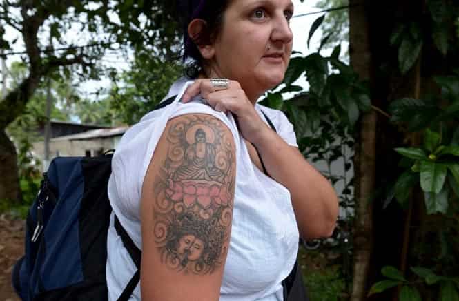 A British tourist poses for a photograph to display a tattoo of the Buddha,in Colombo. Sri Lanka has detained a female British tourist for having a Buddha tattoo on her right arm and ordered her deportation. (AFP Photo)</em) A British tourist poses for a photograph to display a tattoo of the Buddha,in Colombo. Sri Lanka has detained a female British tourist for having a Buddha tattoo on her right arm and ordered her deportation. (AFP Photo)</em)