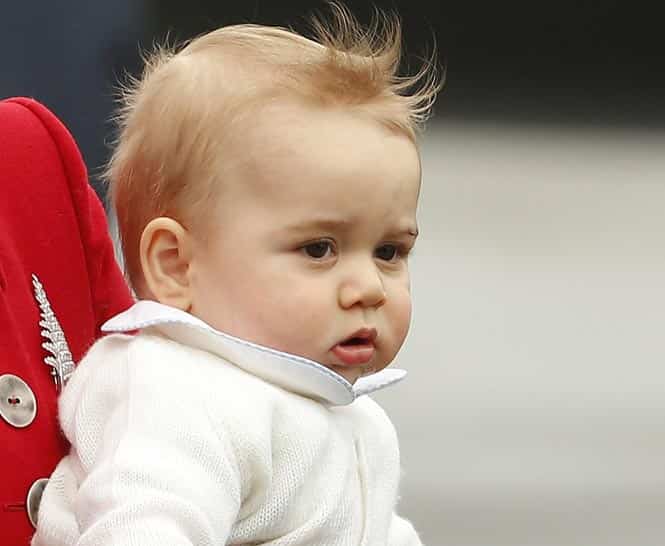 Catherine, the Duchess of Cambridge, holds her son Prince George after disembarking their plane with her husband Britain's Prince William in Wellington. (Reuters Photo)</em)