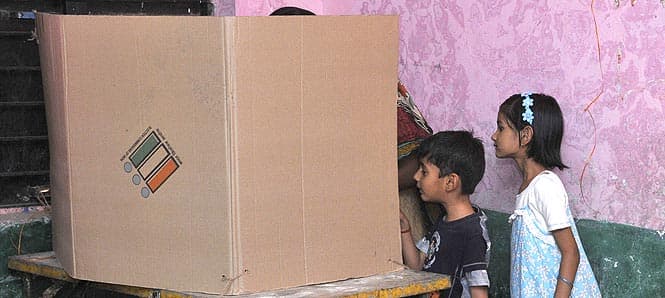 Kids curiously look in the polling cubical as their mother cast her vote at a polling station at Kolar in Bhopal. Photo by Gagan Nayar/ Hindustan Times Kids curiously look in the polling cubical as their mother cast her vote at a polling station at Kolar in Bhopal. Photo by Gagan Nayar/ Hindustan Times