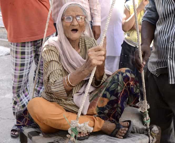 A man carries his grandmother to a polling station to vote at Dhalai district in Tripura. Photo by Reuters A man carries his grandmother to a polling station to vote at Dhalai district in Tripura. Photo by Reuters