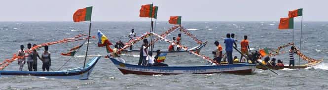 BJP supporters ride on the fishing boats to campaign for their party on the outskirts of the Chennai. Photo by Reuters BJP supporters ride on the fishing boats to campaign for their party on the outskirts of the Chennai. Photo by Reuters