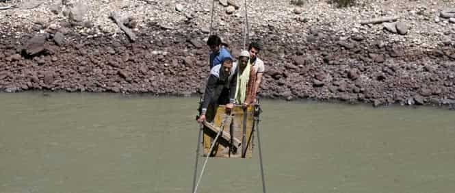 People cross the Chenab river on a trolley tied to wires to cast their vote at Harshi village in Doda district, north of Jammu. Photo by Reuters People cross the Chenab river on a trolley tied to wires to cast their vote at Harshi village in Doda district, north of Jammu. Photo by Reuters