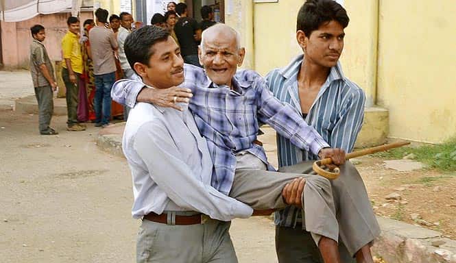 An elderly voter is carried after he cast his vote at a polling station in Barmer. Photo by PTI An elderly voter is carried after he cast his vote at a polling station in Barmer. Photo by PTI