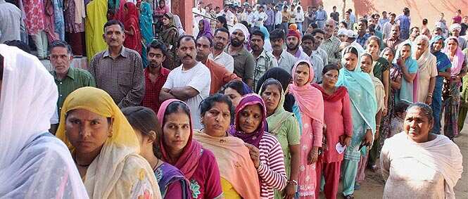Voters stand in queues to cast their votes at a polling station in Jammu. Photo by PTI Voters stand in queues to cast their votes at a polling station in Jammu. Photo by PTI