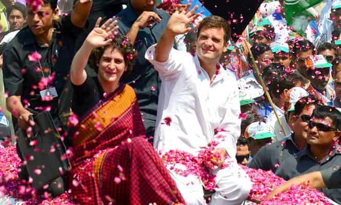 Congress vice-president Rahul Gandhi and his sister Priyanka Gandhi are showered with flower petals by supporters before Rahul filed his nomination for the upcoming Lok Sabha elections in Amethi. (AFP photo)
</div) Congress vice-president Rahul Gandhi and his sister Priyanka Gandhi are showered with flower petals by supporters before Rahul filed his nomination for the upcoming Lok Sabha elections in Amethi. (AFP photo)
</div)