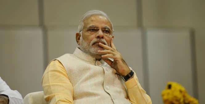Narendra Modi looks on during the oath taking cermony of the new Chief Minister of Gujarat Anandiben Patel at the Mahatma Mandir in Gandhinagar, Ahmedabad. (AFP Photo)</em)
