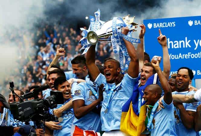 Manchester City's captain Vincent Kompany (C) celebrates with the English Premier League trophy following their soccer match against West Ham United at the Etihad Stadium in Manchester, northern England. (Reuters) </em) Manchester City's captain Vincent Kompany (C) celebrates with the English Premier League trophy following their soccer match against West Ham United at the Etihad Stadium in Manchester, northern England. (Reuters) </em)