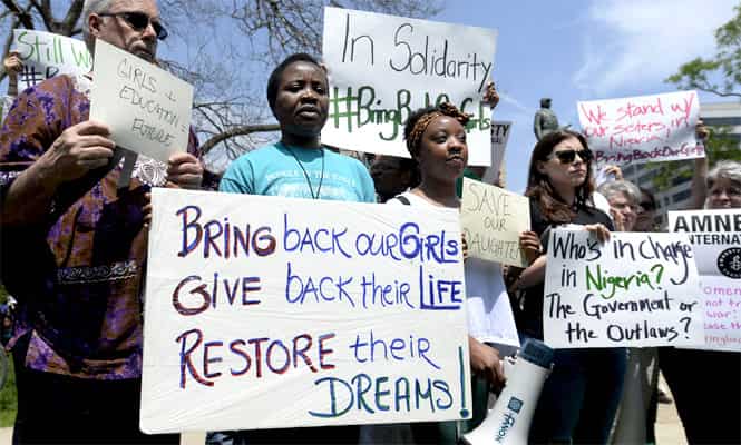 People attend a vigil in support and solidarity with the abducted girls of the Government Girls School in Chibok, Nigeria, at Farragut Square in Washington DC, USA. (EPA Photo)</em) People attend a vigil in support and solidarity with the abducted girls of the Government Girls School in Chibok, Nigeria, at Farragut Square in Washington DC, USA. (EPA Photo)</em)