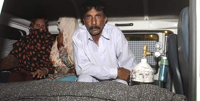 Mohammad Iqbal, right, husband of Farzana Parveen sits in an ambulance next to the body of his pregnant wife who was stoned to death by her own family, in Lahore, Pakistan.(AP Photo)</em) Mohammad Iqbal, right, husband of Farzana Parveen sits in an ambulance next to the body of his pregnant wife who was stoned to death by her own family, in Lahore, Pakistan.(AP Photo)</em)
