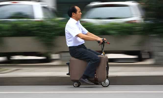 Chinese farmer He Liangcai riding a motorized suitcase-scooter that he invented. (AFP Photo)</em>
</div) Chinese farmer He Liangcai riding a motorized suitcase-scooter that he invented. (AFP Photo)</em>
</div)