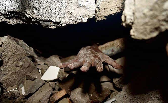 A trapped construction worker waiting for help in the debris of under construction building which collapsed in Porur near Chennai. (PTI photo)</em> </div) A trapped construction worker waiting for help in the debris of under construction building which collapsed in Porur near Chennai. (PTI photo)</em> </div)