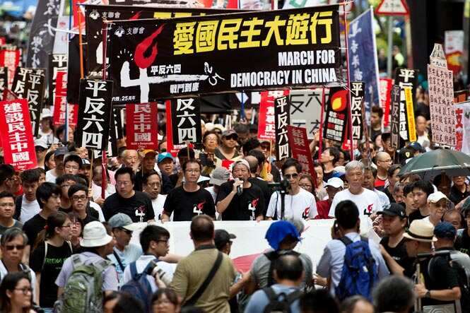 Protesters hold banners and placards as they shout slogans at a rally in Hong Kong ahead of the 25th anniversary of the June 4, 1989 Tiananmen Square crackdown. (AFP photo) 
</div)