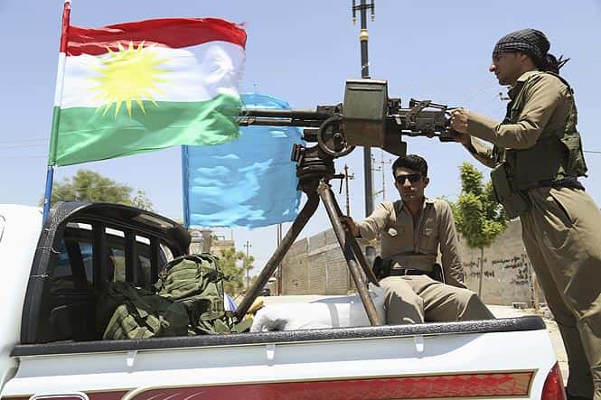 A military convoy drives towards Kirkuk, to reinforce Kurdish Peshmerga troops in Kirkuk. (Reuters photo)</em>
</div) A military convoy drives towards Kirkuk, to reinforce Kurdish Peshmerga troops in Kirkuk. (Reuters photo)</em>
</div)