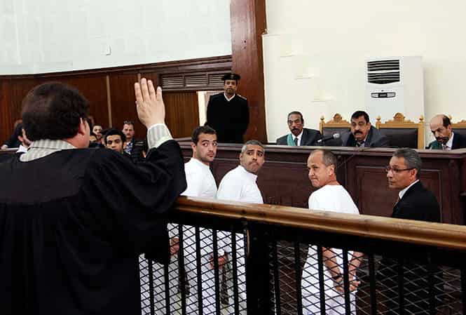 Al-Jazeera English producer Baher Mohamed, center left, Canadian-Egyptian acting Cairo bureau chief Mohammed Fahmy, center, and correspondent Peter Greste, second right, appear in court along with several other defendants during their trial on terror charges, in Cairo, Egypt. (AP Photo)</em) Al-Jazeera English producer Baher Mohamed, center left, Canadian-Egyptian acting Cairo bureau chief Mohammed Fahmy, center, and correspondent Peter Greste, second right, appear in court along with several other defendants during their trial on terror charges, in Cairo, Egypt. (AP Photo)</em)