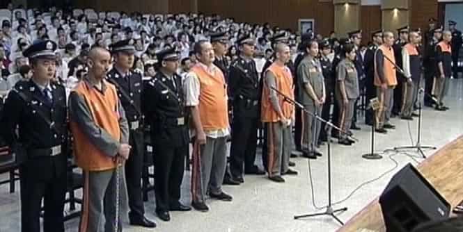 Defendants stand at a court in the Xinjiang regional capital of Urumqi, China. The court sentenced three people to death on Monday for planning a deadly car ramming at Beijing's iconic Tiananmen Gate last year that was blamed on Muslim separatists. (AP Photo)</em) Defendants stand at a court in the Xinjiang regional capital of Urumqi, China. The court sentenced three people to death on Monday for planning a deadly car ramming at Beijing's iconic Tiananmen Gate last year that was blamed on Muslim separatists. (AP Photo)</em)